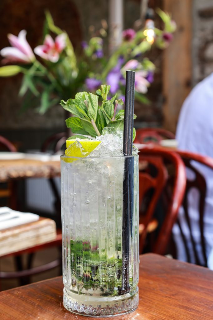 Mojito with fresh mint and lime on a café table